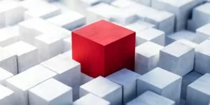 Illustration with three-dimensional cubes, with one red one highlighted.