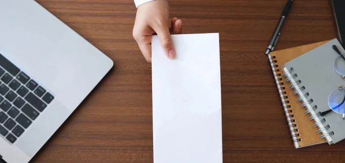 Hand holding a blank sheet on a desk for Supply Chain analysis and consulting activities