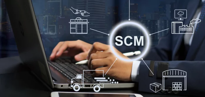 Professional at the computer with SCM interface for digital Supply Chain management